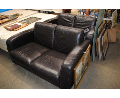 A brown leather upholstered two seater sofa