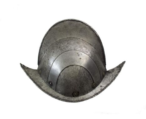An early 17th Century German Black and White Comb Morion, two-piece skull of characteristic form with tall raised comb and do