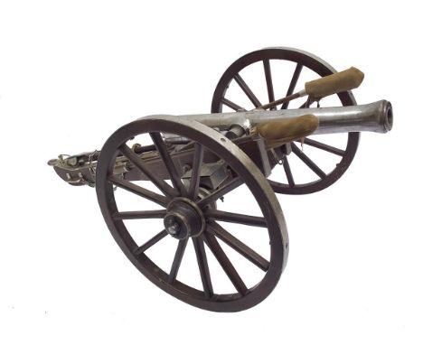A good model field cannon, 15inch part bored barrel with plain trunnions and spherical cascabel, mounted on its steel finishe