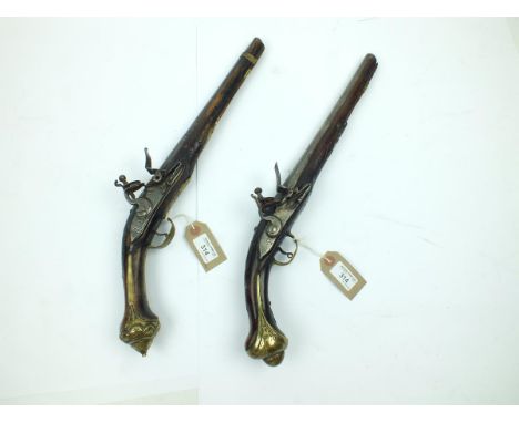 Two Turkish flint lock holster pistols, the first with 12.5inch 20-bore two-stage barrel, border and scroll engraved stepped 