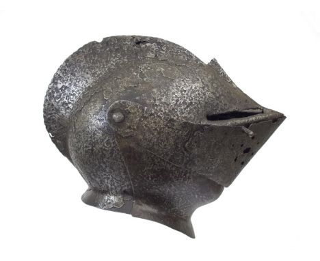 A 16th Century French close helmet for field use, the one-piece skull with roped comb, the sharply pointed visor with roped m