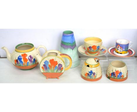 CLARICE CLIFF. A GROUP OF A. J. WILKINSON LTD CROCUS PATTERN TEAWARE, COMPRISING TWO TEAPOTS, CUP AND SAUCER, TWO BEE SKEP HO