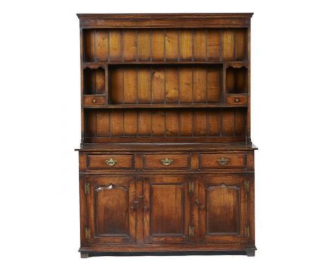 AN OAK DRESSER, 20TH C  the boarded rack with spice drawers, the lower part with moulded drawers and panelled doors, 187cm h;
