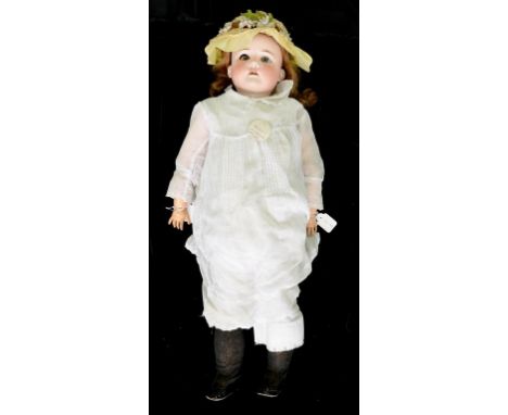 A GERMAN BISQUE HEADED BEBE ELITE DOLL, THE MAX HANDWERCK HEAD WITH GLASS EYES AND OPEN MOUTH WITH UPPER TEETH, ON JOINTED CO