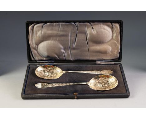 GOOD, CASED PAIR OF EDWARDIAN SILVER-GILT SERVING SPOONS, chased with leafage and scalloped shells, the terminals engraved wi