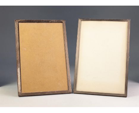 GEORGE V, TWO SIMILAR SILVER FRONTED DESK TOP PHOTOGRAPH FRAMES WITH OAK WOOD EASEL SUPPORTS, one engine turned, 11 Â¾â€ x 8â