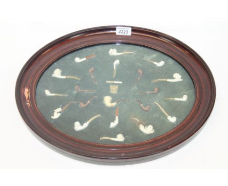 Rare early 20th century pipe manufacturers' sample case with an array of miniature carved meerschaum, porcelain and briar pip