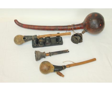 Three antique African gourd form pipes, together with African pipe section (4)