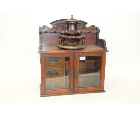 Early 20th century walnut smokers cabinet superstructure pierced for pipes, enclosed below by pair of glazed shelves with ban