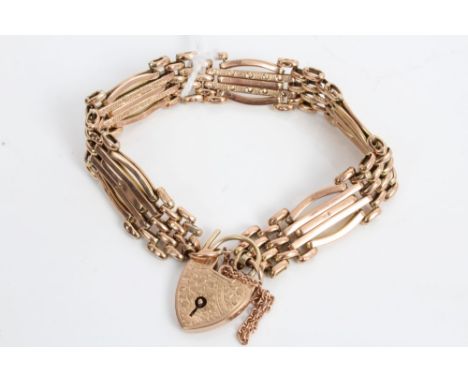 Edwardian rose gold / rose-coloured metal gate bracelet with articulated links and padlock clasp, stamped - '9ct' CONDITION R