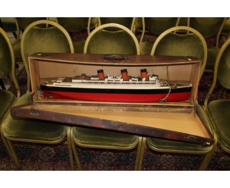 Live Steam wooden model of The Queen Mary, by Bassett-Lowke Ltd., with three funnels, red, white and black livery, label for 