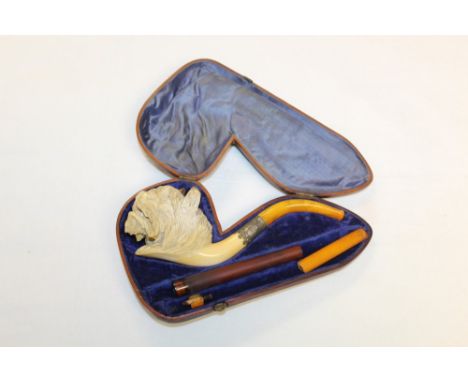 Good late 19th century meerschaum pipe carved in the form of a lion's head, with silver collar and amber mouthpiece, 20cm, in