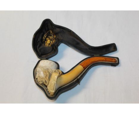 Late 19th century meerschaum pipe carved in the form of a Balkan man's head with large moustache, wearing a cap, with amber m