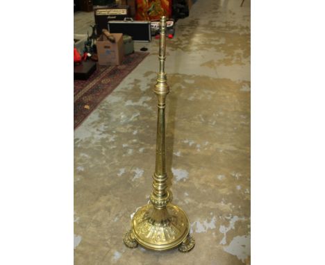 Victorian brass standard lamp - the flared knopped column on circular spread base and projecting semi-circular feet, 126cm hi