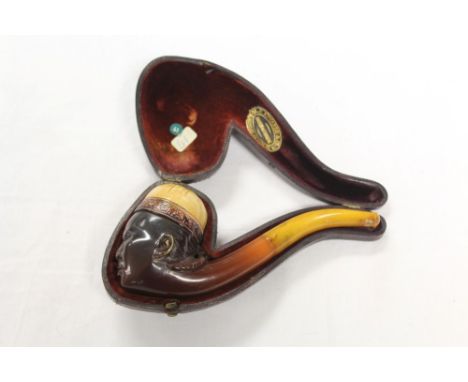 Good late 19th century meerschaum pipe carved in the form of a Chinaman's head with coiled pigtail and wearing a hat, with am