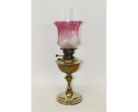 Victorian 'Veritas' oil lamp with circular burner and tube wick, brass reservoir, on tapering brass column and circular base,