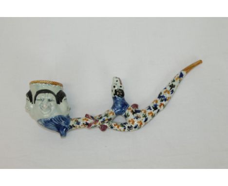 Highly unusual early 19th century English Prattware pipe, the bowl modelled with four grotesque masks, the undulating stem wi
