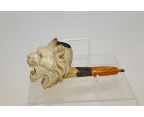 Finely carved late 19th century meerschaum pipe, the bowl in the form of a roaring lion, with carved amber shank and white me