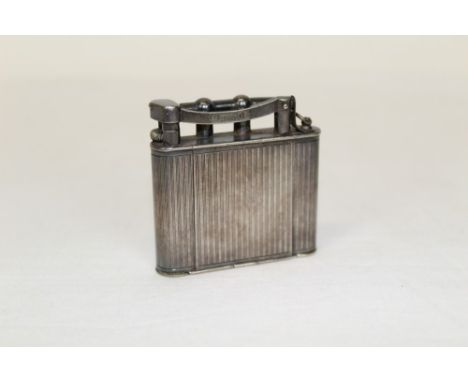 Early 20th century Dunhill lighter and compact with separate lipstick, powder container and mirror, in an engine-turned case,