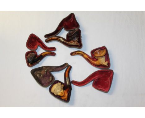 Late 19th century meerschaum pipe carved in the form of a lady's head, wearing a bonnet, with silver collar and amber mouthpi