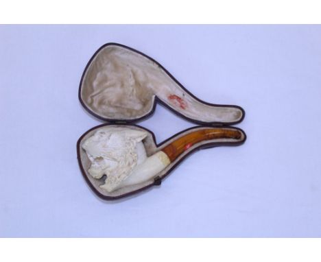 Finely carved Continental meerschaum pipe, the bowl carved as a snarling lion, amber mouthpiece, 16cm long, cased CONDITION R