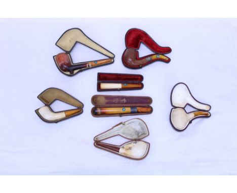 Collection of plain meerschaum pipes and cheroot holders - all cased, together with another carved with horses   CONDITION RE