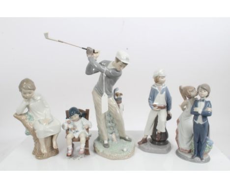 Five Lladro porcelain figures - golfer, boy with model boat, girl on tree stump, girl kissing boy on cheek and girl with doll