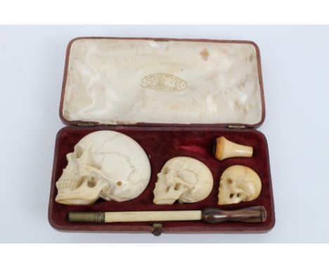 Unusual late 19th century graduated set of three meerschaum pipe / cheroot holders carved in the form of human skulls, 3cm - 
