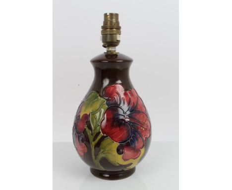 Moorcroft Pottery lamp decorated in the Hibiscus pattern on brown ground - impressed mark to base, 21cm high