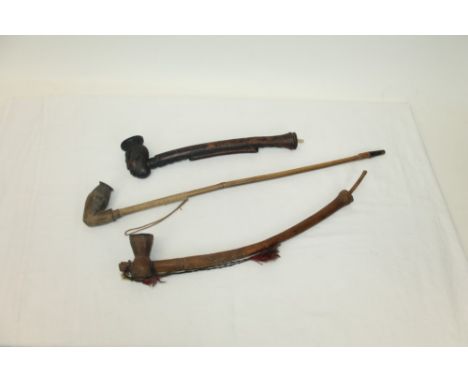 Antique West African Bakuba carved wood pipe, 51cm long, together with another similar and an African tribal pipe carved with
