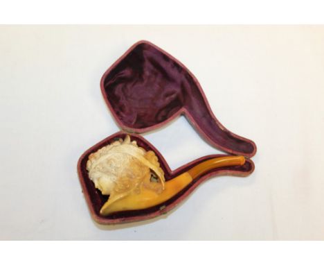 Late 19th century meerschaum pipe carved with a lady's' head wearing a floral hat within ribbons, with amber mouthpiece, 15cm