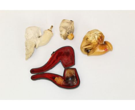 Finely carved 19th century novelty meerschaum pipe in the form of an elephant head with curling trunk, together with three pa