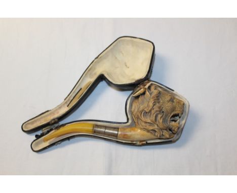 Large late 19th century meerschaum pipe carved in the form of a lion's head, with silver collar and amber mouthpiece, 23.5cm,