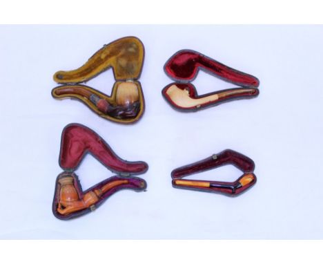 Novelty carved meerschaum cheroot holder of plain form, carved with amber head bursting through the bowl, amber mouthpiece, 1