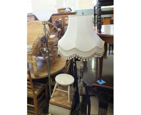 A metal floor standing uplighter, an onyx and gilt metal standard lamp and a loom bin