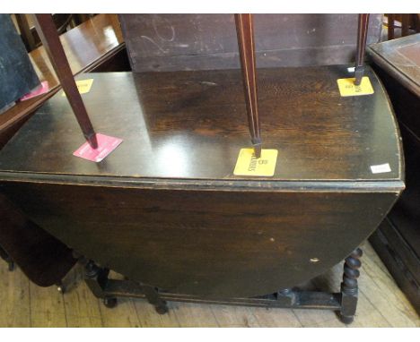 An oval Oak barley twist gate leg table