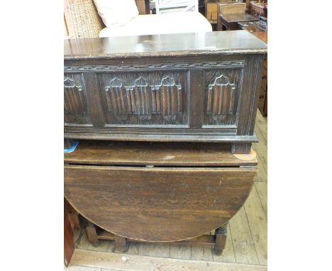 An oval Oak gate leg table and a blanket chest