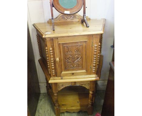 An usual Pine trapezium shaped cupboard with carved door shelf back