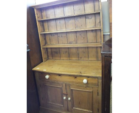 A Pine shelf back dresser with single drawer and two door cupboard below