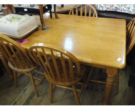 A modern rectangular Beechwood dining table and four stick back chairs