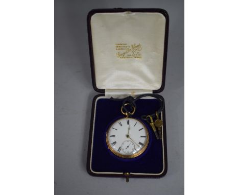 An 18 Carat Gold Open Face Pocket watch with Roman Numerals to Enamel Face and Subsidiary Seconds Dial. Two Keys. 