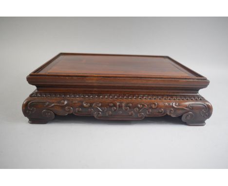 A Good Quality Chinese Hardwood Rectangular Stand with Blind Carved Decoration and Four Scroll Feet. Signed. 27x22.5cms 