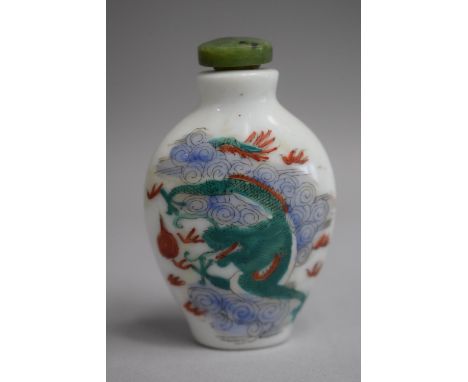 A Chinese Ceramic Snuff Bottle of Flattened Spade Form decorated with Famille Vert Colouration depicting Dragon amongst Cloud