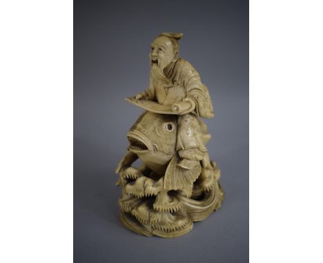 A Signed 19th Century Chinese Ivory Okimono of Elder with Scroll Riding Carp. 15cms High 