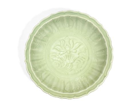 A LONGQUAN BARBED RIM 'LOTUS' DISHMing Dynasty, 15th centuryFluidly carved to the centre with a large lotus bloom issuing fro