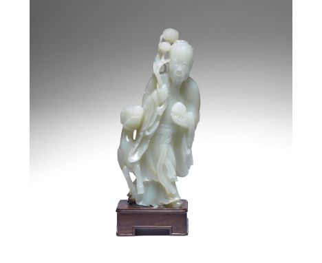 A PALE GREEN JADE 'SHOULAO AND DEER' GROUPLate Qing DynastyThe figure modelled holding a peach in his left hand and flowering