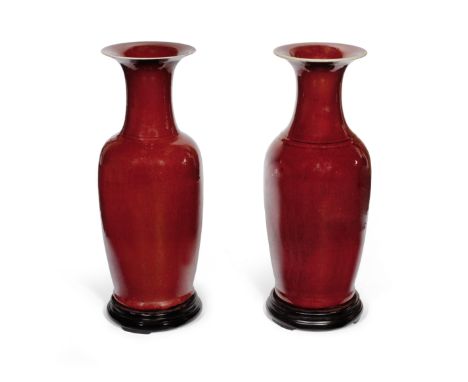 A LARGE PAIR OF SANG-DE-BOEUF GLAZED BALUSTER VASESLate Qing DynastyEach of the cylindrical vessels rising from a straight fo
