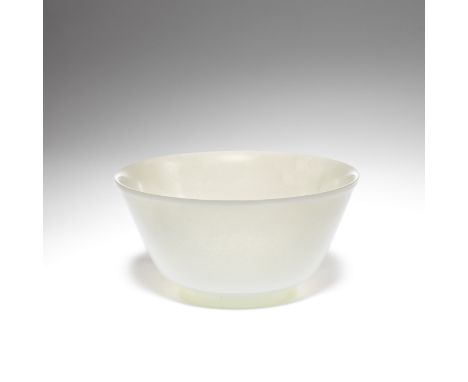 A PALE JADE BOWLQing DynastyCarved with deep tapering sides rising from a crisply-cut foot ring to a gently everted rim, the 