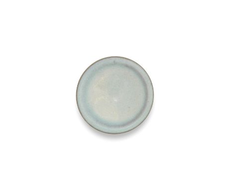 A SMALL JUN WARE DISHSong DynastyThe shallow vessel with a gently rounded rim, covered in a delicate sky-blue glaze, transmut