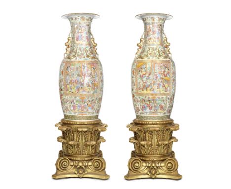 A LARGE PAIR OF CANTON FAMILLE ROSE VASES19th centuryWith applied gilt lion and cub handles and guei dragons at the shoulders